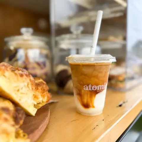 Atomic iced coffee beside fresh cheese scones on the cabinet