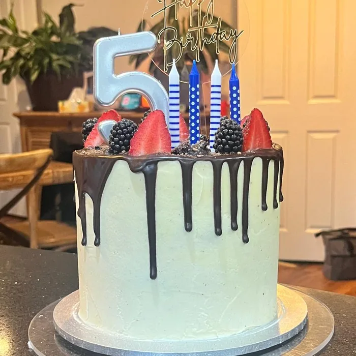 Blue number five birthday cake with strawberries
