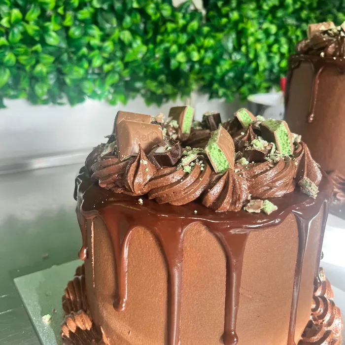 Chocolate drip cake topped with fresh berries