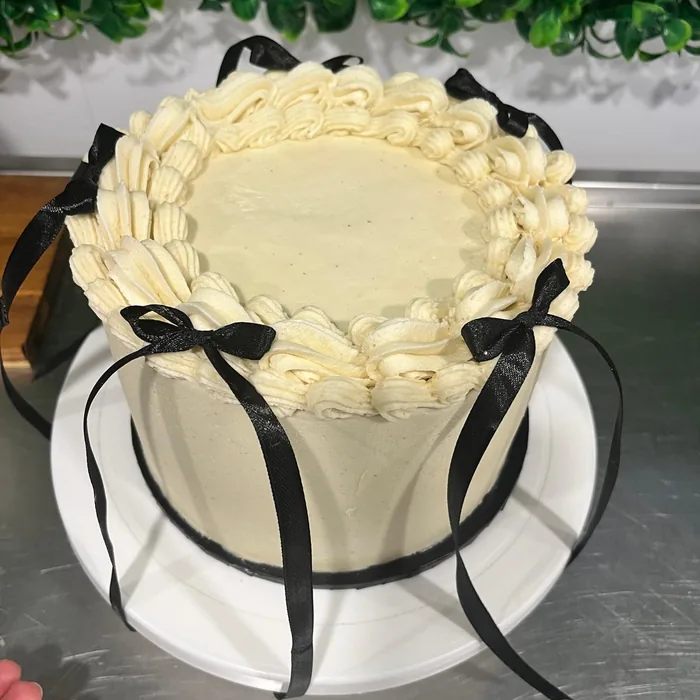 White cake with black ribbon bows