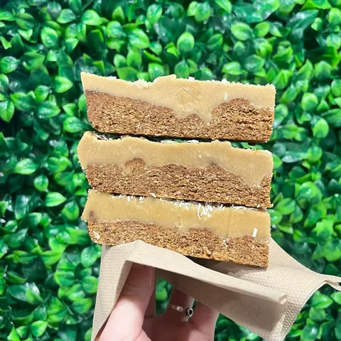Stack of caramel oat slices with coconut
