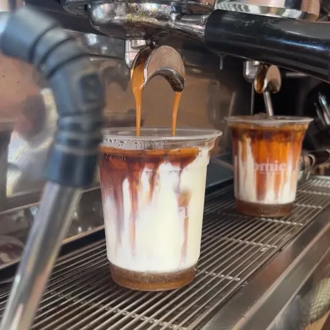 Espresso pouring over iced milk at the Mini Misfits coffee machine