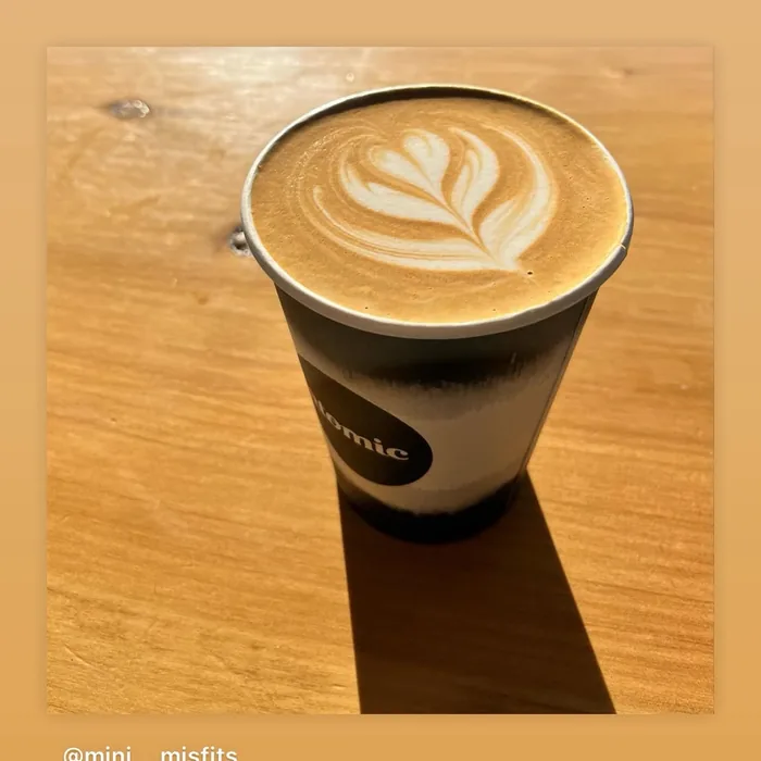 Latte with fern art on a warm background