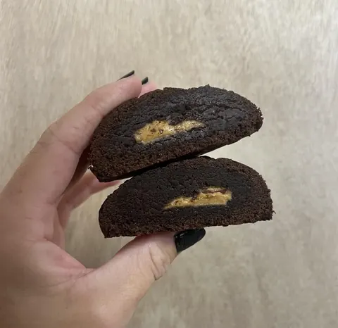 Peanut butter stuffed chocolate cookie cut in half
