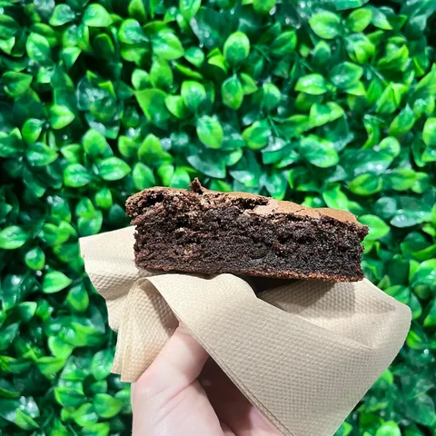 Fudgy chocolate brownie held up