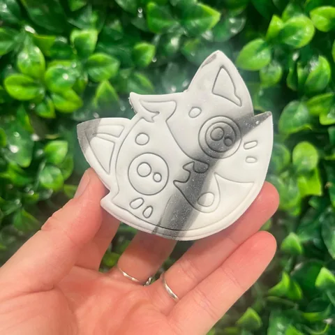 Misfit cat-shaped sugar cookie held up